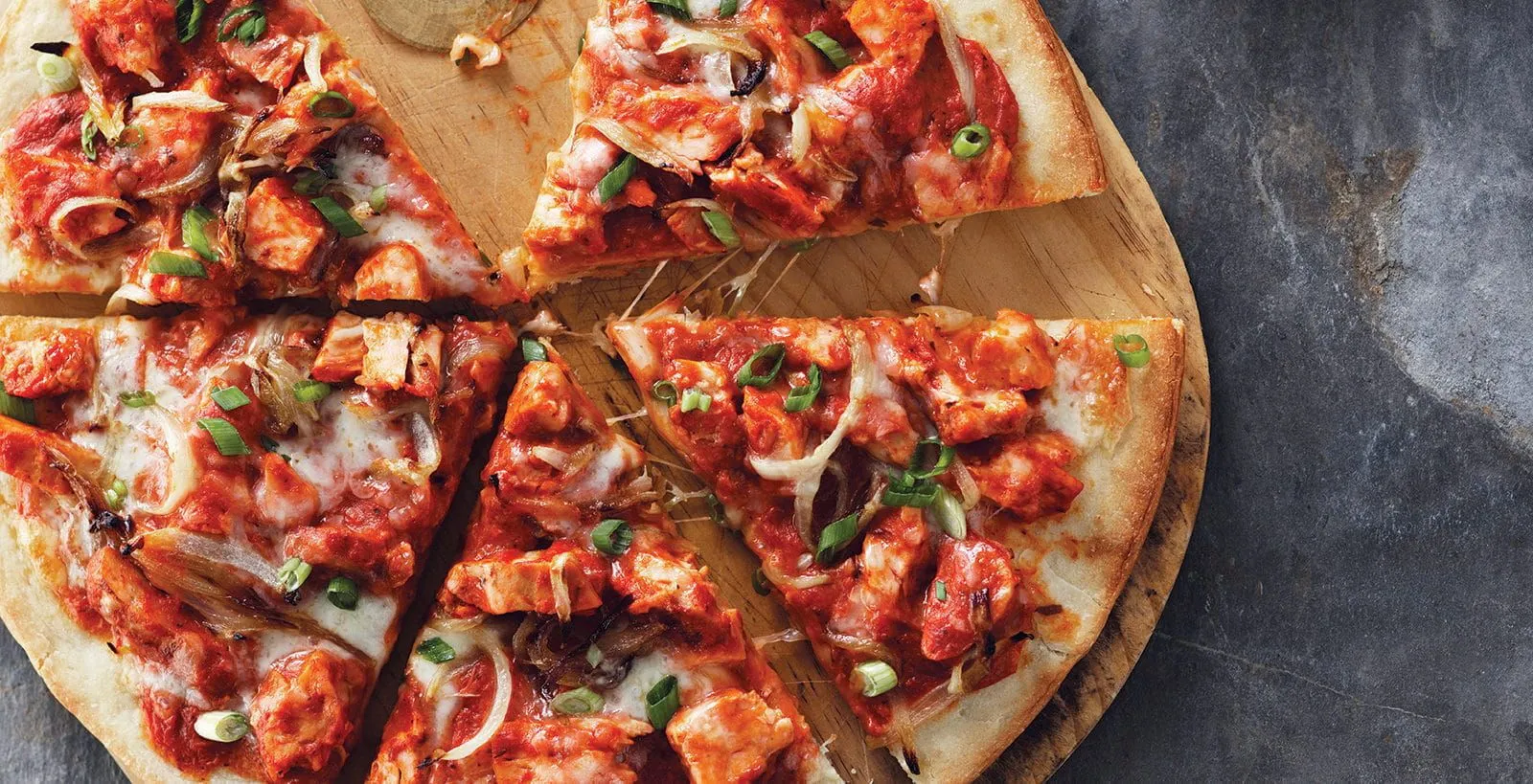 Delicious Butter Chicken pizza at Sizzling Spice in Calgary, AB